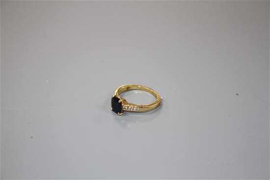 A modern 18ct gold and oval cut sapphire ring, with diamond set shoulders, size M, gross weight 3.4 grams.